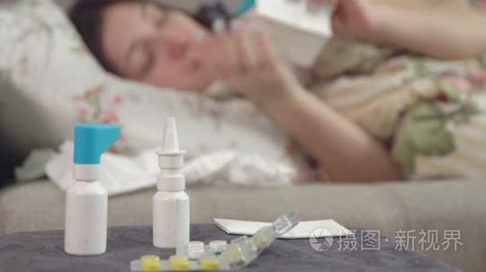片剂,在椅子上喷雾和年轻生病的女孩使用餐巾在卧室的背景短视频