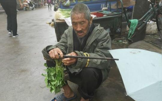 农村八旬老人摆摊卖菜阴雨中摆摊却不为挣钱真相令人心酸