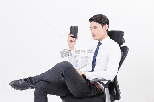 坐在办公椅上喝咖啡的商务人
