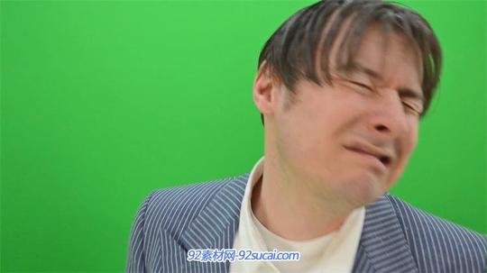 绿色背景拍打拳打男人脸部表情变化慢动作高清视频实拍绿布素材